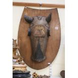 A reproduction horse armour chanfron with armorial escutcheon, mounted on a board [A] FOR DETAILS OF