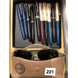 Ten Parker pens in blue, black, red and green and a pair of Ray-Ban sunglasses. FOR DETAILS OF