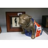 A Royal Doulton pottery Great War figure of a seated British bulldog in matt bronze, draped in the