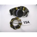 An onyx Scottish brooch and an onyx flexible bracelet. FOR DETAILS OF ONLINE BIDDING ON THIS LOT