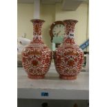 A pair of Chinese porcelain vases, decorated in iron red and gold with a formal lotus panel and shou