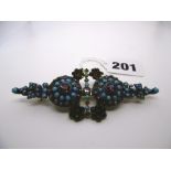 An impressive garnet and turquoise brooch, made-up, mainly in silver, with a little gold. FOR