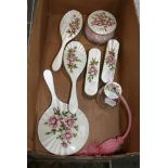 A fine Elizabeth II silver and enamel dressing table service, painted with pink roses on a guilloche