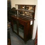 An early 19th century chiffonier in rosewood with a mirrored and shelved superstructure and turned