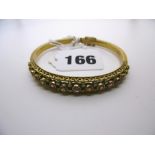 A ruby and diamond antique bangle. FOR DETAILS OF ONLINE BIDDING ON THIS LOT CONTACT BAINBRIDGES. WE