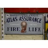 An enamel Atlas Assurance advertising sign with the writing Established in the Reign of George III