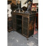 A Regency black lacquered Chinoiserie dwarf bookcase of shelves partly enclosed by two grilled doors