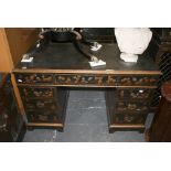 A modern pedestal desk of nine drawers in black lacquer and gilt with Chinoiserie decoration. FOR