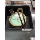 A Victorian compass by Elliott Bros., Strand, London, in brass with green dial, complete with cover,