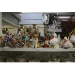 A miscellaneous collection of pottery and porcelain, comprising figures, models of dogs and a