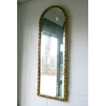 A pretty rectangular bevelled mirror with a dome top in a moulded gilt frame. [by front door] FOR