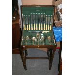 A set of EPNS cutlery in a fitted oak table on barley-twist legs. FOR DETAILS OF ONLINE BIDDING ON