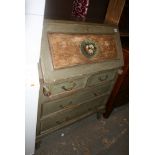 A pretty green painted bureau, the fall with a central floral medallion above four drawers. FOR