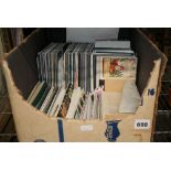 A large carton of Royal Mail stamp folders and a quantity of First Day Covers