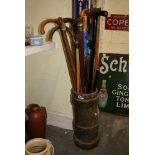 An antique leather shot carrier, together an umbrella and 12 walking canes [corner next to s 69] FOR