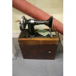 A Singer table-mounted sewing machine, with instruction manual [floor below s 82] FOR DETAILS OF