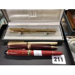 Four pens, comprising: a Dunhill gilt-metal fountain pen with 750 nib, in original box; a