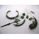 A turquoise bangle, a sword brooch, a crescent brooch, two pairs of earrings and a horn of plenty