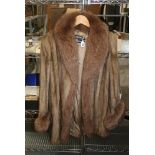 A lady's light brown mink fur jacket with fox fur trim and Grosvenor Harrods label [upstairs rail by