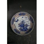 A Chinese porcelain lobed saucerdish, well painted in underglaze blue and red with insects in flight