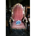 A Continental open armchair of dramatic form, the gilt carved frame in the Baroque style, on