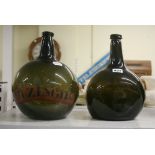 Two antique large olive glass bottles, of shaft and globe form, one with remains of painted pharmacy