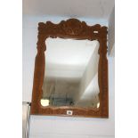 A small rectangular Eastern wall mirror with floral carved frame. FOR DETAILS OF ONLINE BIDDING ON