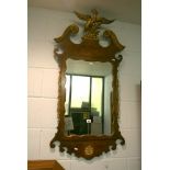 An early Georgian-style wall mirror in mahogany and gilt with exotic carved bird surmount and swan