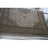 A machine-made small carpet in the Eastern style in tones of beige. [railings] FOR DETAILS OF ONLINE
