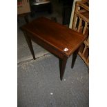 An early 19th century mahogany tea table cross-banded and with inlaid decoration, the hinged top