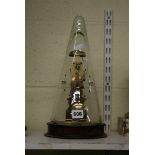 A modern German skeleton clock by Franz Hermle, under conical glass cover on wood base [A] FOR