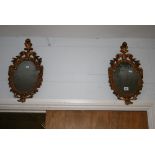 A pair of small Italianate shield-shaped mirrors with feather surmounts and carved frames. FOR