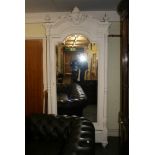 A 19th century Continental armoire painted white, the dome-topped bevelled mirrored door flanked
