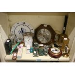 Two shelves of collectors' items and toys and games, including aneroid barometers, playing cards,