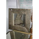 A modern square mirror in a broad silvered frame. FOR DETAILS OF ONLINE BIDDING ON THIS LOT