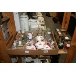 A small collection of decorative collectables including model cottages, Venetian-style wall masks,