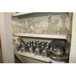 A collection of various glass items, including decanters and stoppers, jugs, vases, and drinking