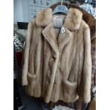 A lady's dark blonde mink fur short coat with three decorative buttons and front pockets [rail top