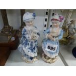 Two 19th century Meissen porcelain figures, each of a girl holding a toy lamb, model C90, one in