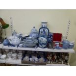 A shelf of mainly Oriental blue and white china including vases and covers, rice bowls, knife rests,