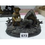 A 19th century inkwell in bronze and ormolu, probably French, as an infant girl feeding a dog in a
