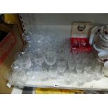 A collection of cut glass red and white wine glasses, tumblers etc., glass decanters and stoppers