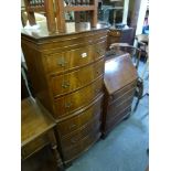 A reproduction bow-fronted chest on chest of six drawers and a reproduction small walnut bureau