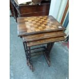 A fine quality antique nest of three rosewood tables, the largest with chequerboard inlay, each