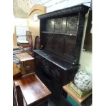 A large 19th century Continental oak dresser with a plate rack and hooks, on a cupboard base FOR