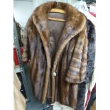 A lady's conker brown mink fur coat with swing back, flared sleeves and shawl collar [rail top of