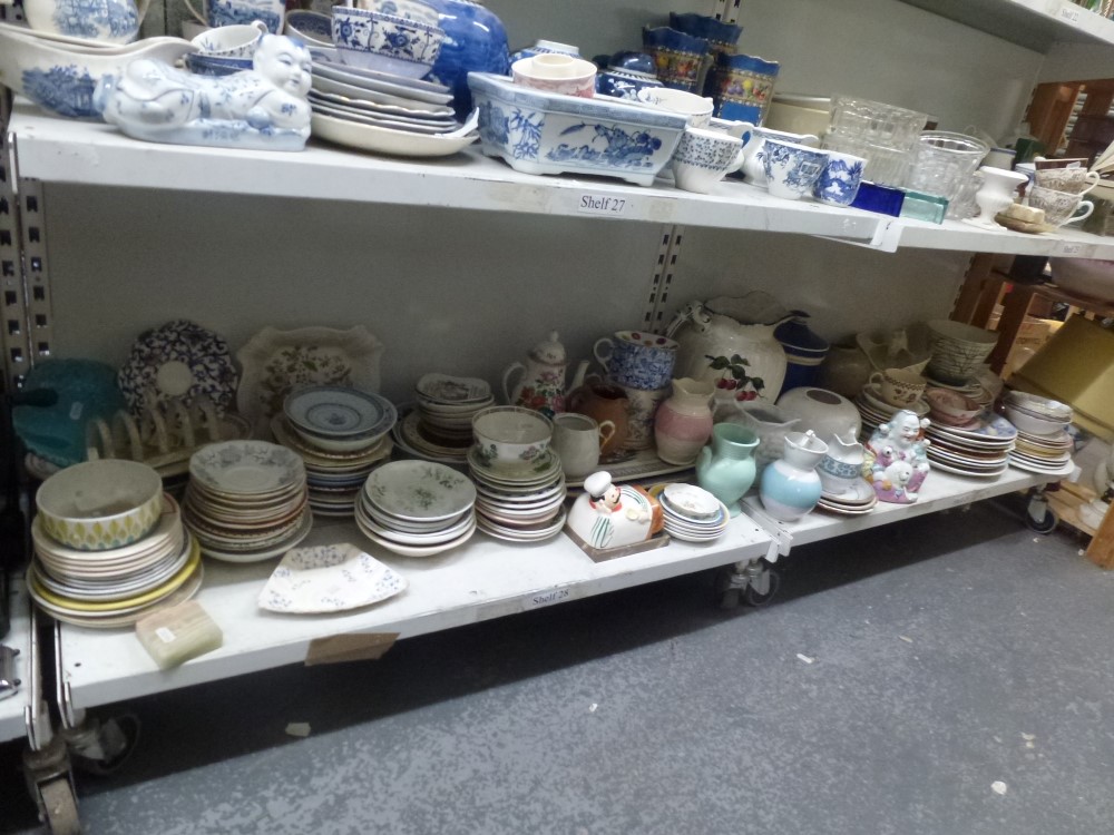 Two shelves of various tea and dinnerware including plates, saucers, toast rack plus large jug,