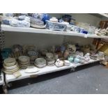 Two shelves of various tea and dinnerware including plates, saucers, toast rack plus large jug,