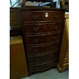 A reproduction bow-fronted mahogany chest of six drawers on splayed bracket feet. FOR DETAILS OF