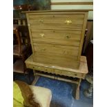 A 19th century pine writing table with original painted decoration on shaped supports with turned